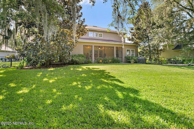 4705 Sawbuck St, Saint Augustine, FL 32092 - rear view of house featuring stucco siding and a sunroom