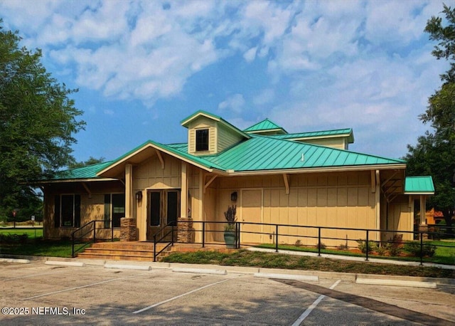 4705 Sawbuck St, Saint Augustine, FL 32092 - view of front of property with a metal roof, uncovered parking, a standing seam roof, and stone siding