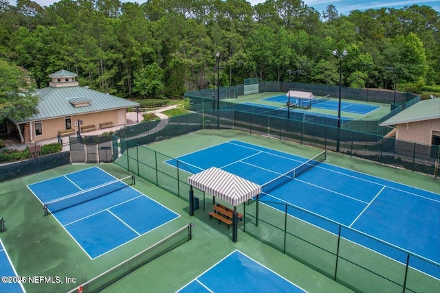 4705 Sawbuck St, Saint Augustine, FL 32092 - view of tennis court with a wooded view