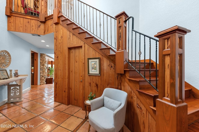 970 Fruit Cove Rd, Saint Johns, FL 32259 - stairway with tile patterned flooring, a towering ceiling, and wooden walls