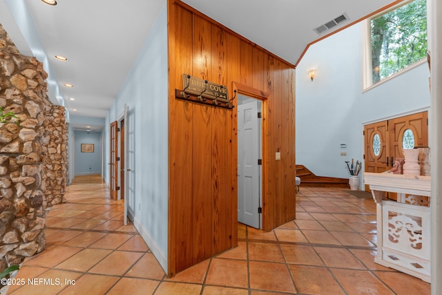 970 Fruit Cove Rd, Saint Johns, FL 32259 - hallway featuring stairs, light tile patterned floors, wooden walls, and recessed lighting