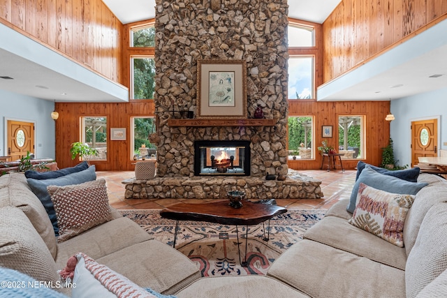 970 Fruit Cove Rd, Saint Johns, FL 32259 - tiled living room with high vaulted ceiling, wood walls, healthy amount of natural light, and a fireplace