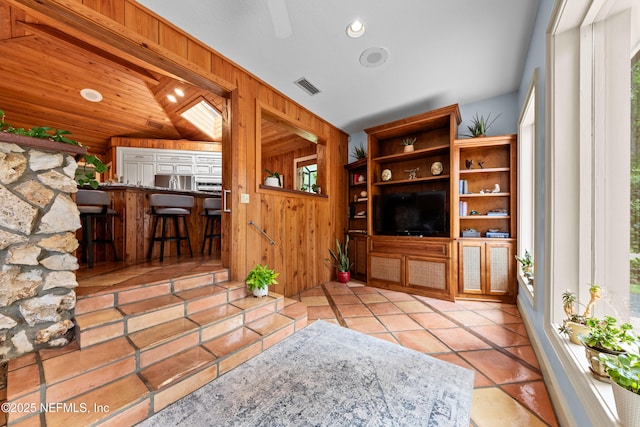 970 Fruit Cove Rd, Saint Johns, FL 32259 - living area featuring wood walls, vaulted ceiling, tile patterned flooring, and recessed lighting