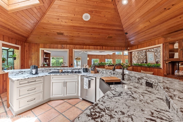 970 Fruit Cove Rd, Saint Johns, FL 32259 - kitchen with stainless steel dishwasher, vaulted ceiling, wood ceiling, wood walls, and light stone countertops