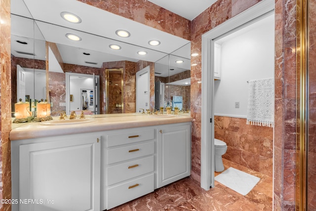 970 Fruit Cove Rd, Saint Johns, FL 32259 - full bath featuring tile walls, double vanity, recessed lighting, marble finish flooring, and wainscoting