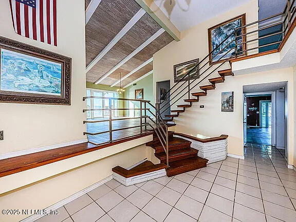 5903 Bimini Way N, Saint Petersburg, FL 33706 - staircase with tile patterned floors, high vaulted ceiling, and beamed ceiling