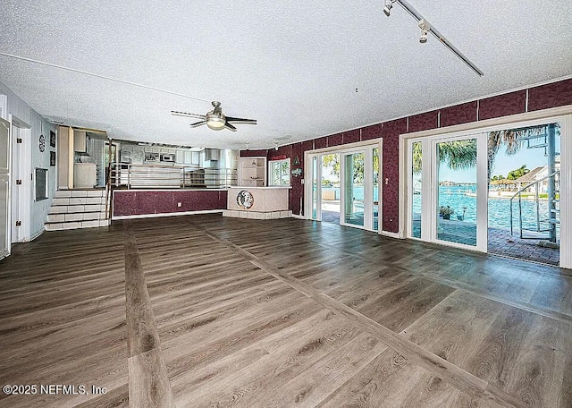 5903 Bimini Way N, Saint Petersburg, FL 33706 - unfurnished living room featuring ceiling fan, wood finished floors, and a textured ceiling