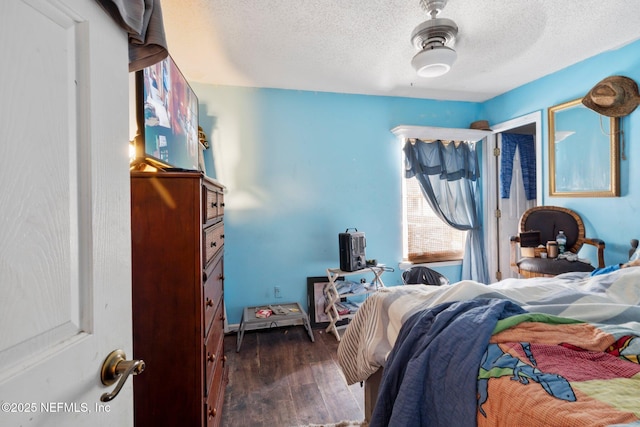 1942 Calusa Trl, Middleburg, FL 32068 - bedroom featuring dark wood-style flooring, a textured ceiling, and a ceiling fan