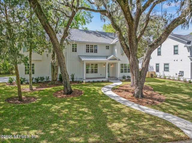 1501 Emma Ln, Neptune Beach, FL 32266 - modern farmhouse style home with board and batten siding, covered porch, a front lawn, and roof with shingles