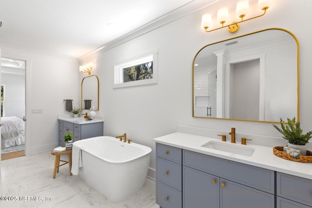 1501 Emma Ln, Neptune Beach, FL 32266 - ensuite bathroom with a freestanding bath, two vanities, marble look tile flooring, and crown molding