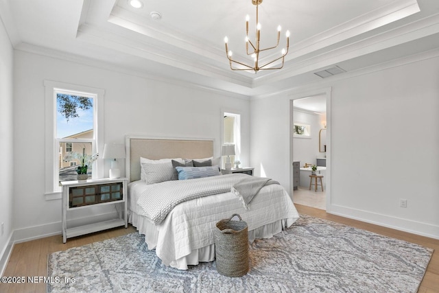 1501 Emma Ln, Neptune Beach, FL 32266 - bedroom with a tray ceiling, a chandelier, crown molding, and wood finished floors