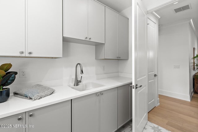 1501 Emma Ln, Neptune Beach, FL 32266 - kitchen with gray cabinets, light countertops, and light wood finished floors