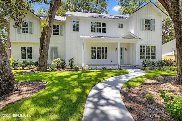 1501 Emma Ln, Neptune Beach, FL 32266 - modern farmhouse style home with board and batten siding, a front lawn, roof with shingles, and a porch