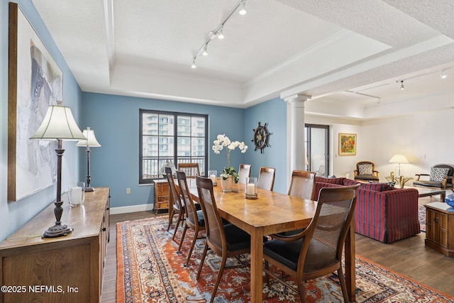 1478 Riverplace Blvd Unit 1605, Jacksonville, FL 32207 - dining space with track lighting, a tray ceiling, ornate columns, wood finished floors, and a textured ceiling