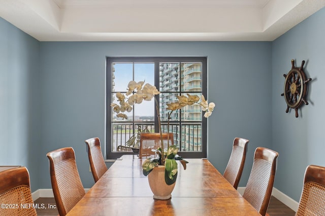 1478 Riverplace Blvd Unit 1605, Jacksonville, FL 32207 - dining area with a tray ceiling and wood finished floors
