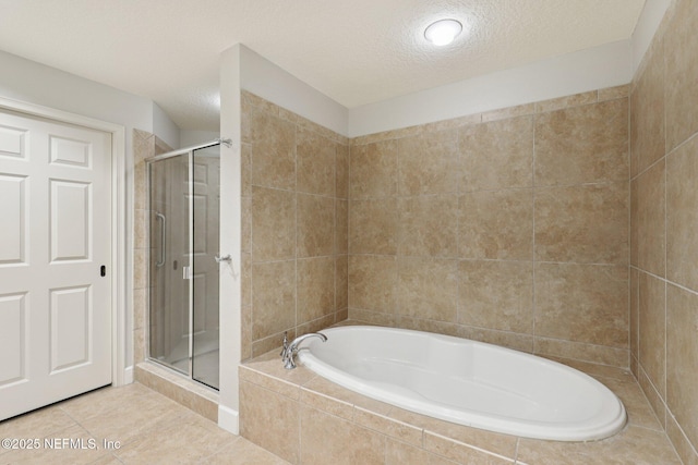 1478 Riverplace Blvd Unit 1605, Jacksonville, FL 32207 - bathroom with a bath, a shower stall, a textured ceiling, and tile patterned floors