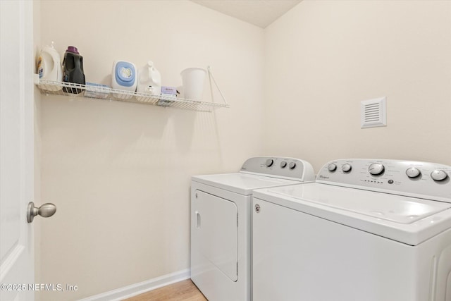 189 Blue Creek Way, Saint Augustine, FL 32086 - washroom with washing machine and clothes dryer and light wood-style flooring