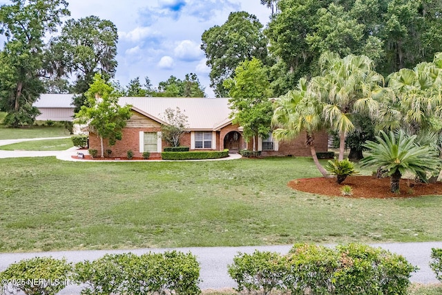 361 SE 34th St, Keystone Heights, FL 32656 - ranch-style home featuring a front yard, a metal roof, and brick siding