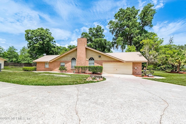 361 SE 34th St, Keystone Heights, FL 32656 - view of front facade featuring driveway, brick siding, a garage, and a chimney