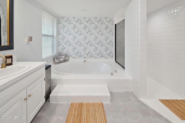 361 SE 34th St, Keystone Heights, FL 32656 - full bathroom featuring a garden tub, vanity, wallpapered walls, walk in shower, and tile patterned flooring