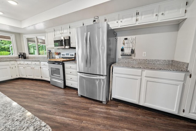 361 SE 34th St, Keystone Heights, FL 32656 - kitchen featuring appliances with stainless steel finishes, dark wood-style floors, white cabinets, light stone counters, and recessed lighting