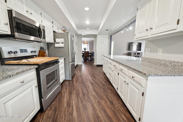 361 SE 34th St, Keystone Heights, FL 32656 - kitchen featuring appliances with stainless steel finishes, dark wood-style flooring, white cabinetry, light stone counters, and recessed lighting