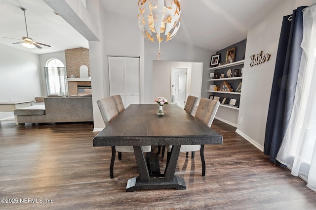 361 SE 34th St, Keystone Heights, FL 32656 - dining space featuring lofted ceiling, ceiling fan, wood finished floors, built in shelves, and a fireplace