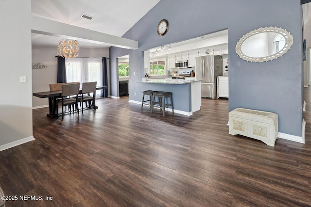 361 SE 34th St, Keystone Heights, FL 32656 - kitchen featuring appliances with stainless steel finishes, a chandelier, white cabinetry, lofted ceiling, and dark wood finished floors