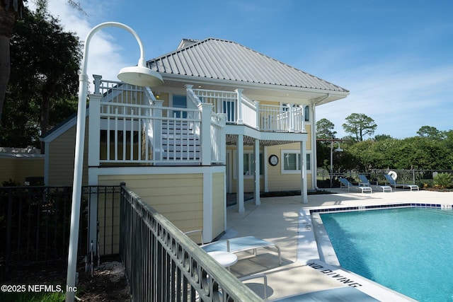 100 Fairway Park Blvd Unit 1004, Ponte Vedra Beach, FL 32082 - back of property with a balcony, a patio area, a community pool, and a metal roof