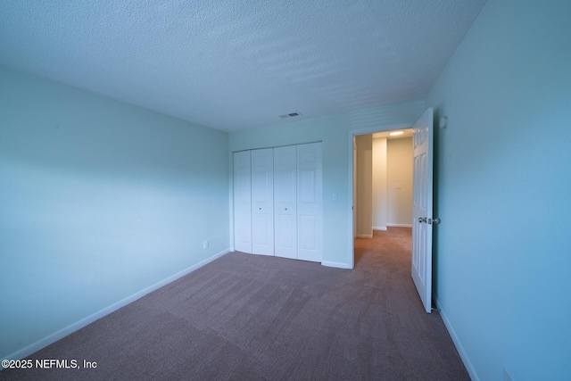 100 Fairway Park Blvd Unit 1004, Ponte Vedra Beach, FL 32082 - unfurnished bedroom with a textured ceiling, a closet, and dark colored carpet