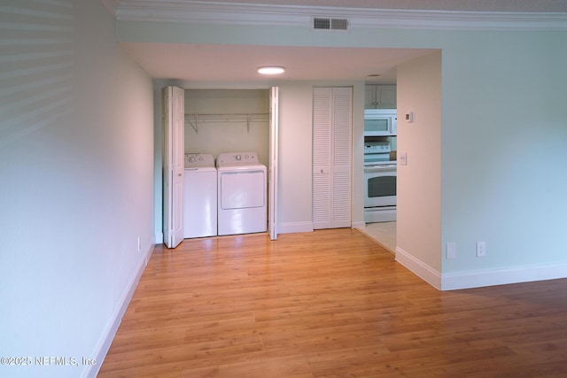100 Fairway Park Blvd Unit 1004, Ponte Vedra Beach, FL 32082 - laundry area featuring light wood-style flooring, ornamental molding, and washing machine and dryer
