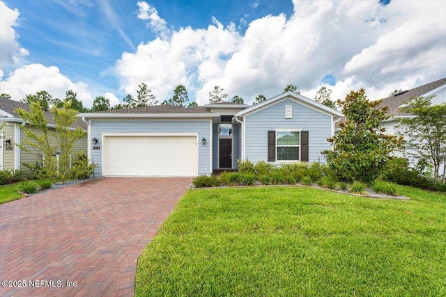 75570 Pondside Ln, Yulee, FL 32097 - ranch-style house with decorative driveway, a garage, and a front lawn