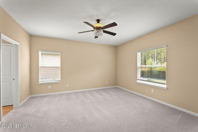 75570 Pondside Ln, Yulee, FL 32097 - empty room with plenty of natural light, light colored carpet, and a ceiling fan