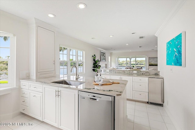 91 San Juan Dr Unit E3, Ponte Vedra Beach, FL 32082 - kitchen with stainless steel dishwasher, a peninsula, crown molding, light tile patterned floors, and recessed lighting