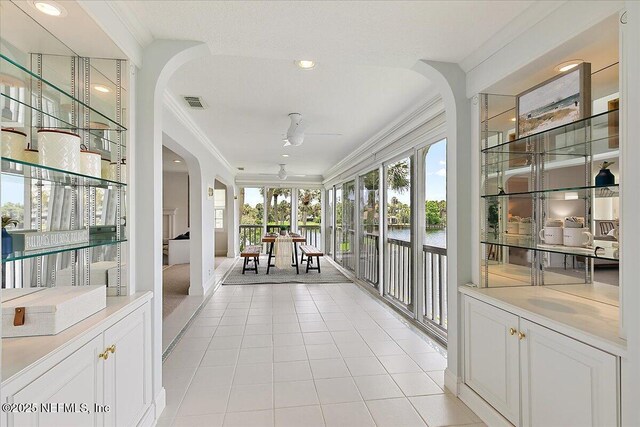 91 San Juan Dr Unit E3, Ponte Vedra Beach, FL 32082 - sunroom / solarium with plenty of natural light, ornamental molding, arched walkways, tile patterned flooring, and a water view