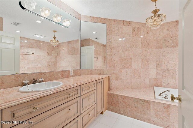 91 San Juan Dr Unit E3, Ponte Vedra Beach, FL 32082 - full bathroom with vanity, tile patterned flooring, tile walls, a tub to relax in, and recessed lighting