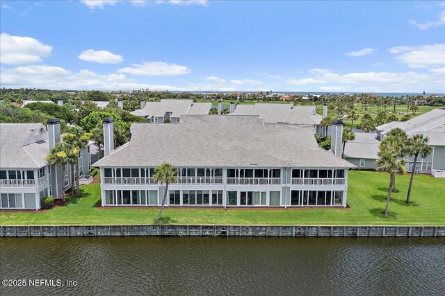 91 San Juan Dr Unit E3, Ponte Vedra Beach, FL 32082 - rear view of property featuring a water view, a chimney, a residential view, and a shingled roof