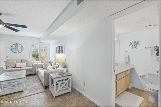 110 Ocean Hollow Ln Unit 114, Saint Augustine, FL 32084 - living room with a textured ceiling, a ceiling fan, and light tile patterned flooring