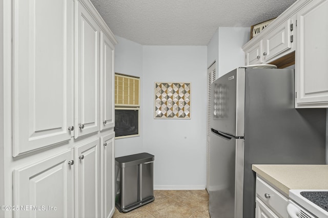 110 Ocean Hollow Ln Unit 114, Saint Augustine, FL 32084 - kitchen with light countertops, white cabinets, and a textured ceiling