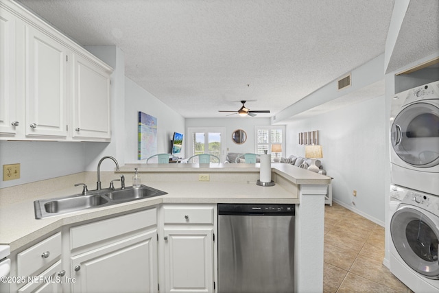 110 Ocean Hollow Ln Unit 114, Saint Augustine, FL 32084 - kitchen featuring dishwasher, stacked washer and clothes dryer, a peninsula, a ceiling fan, and open floor plan