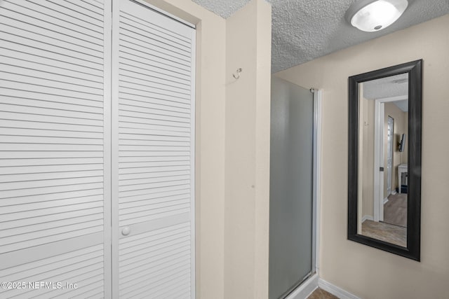 110 Ocean Hollow Ln Unit 114, Saint Augustine, FL 32084 - corridor featuring a textured ceiling and baseboards