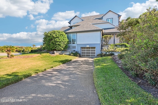 110 Ocean Hollow Ln Unit 114, Saint Augustine, FL 32084 - view of front facade with driveway, a front yard, roof with shingles, and a garage