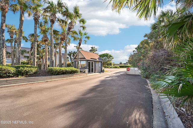 110 Ocean Hollow Ln Unit 114, Saint Augustine, FL 32084 - view of asphalt street featuring traffic signs, a gate, and curbs