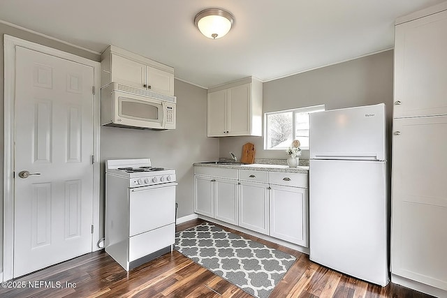 279 Selden Ave, Ormond Beach, FL 32174 - kitchen featuring white appliances, dark wood-style floors, and white cabinetry