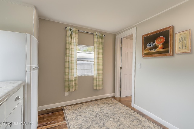 279 Selden Ave, Ormond Beach, FL 32174 - unfurnished dining area with dark wood finished floors and crown molding