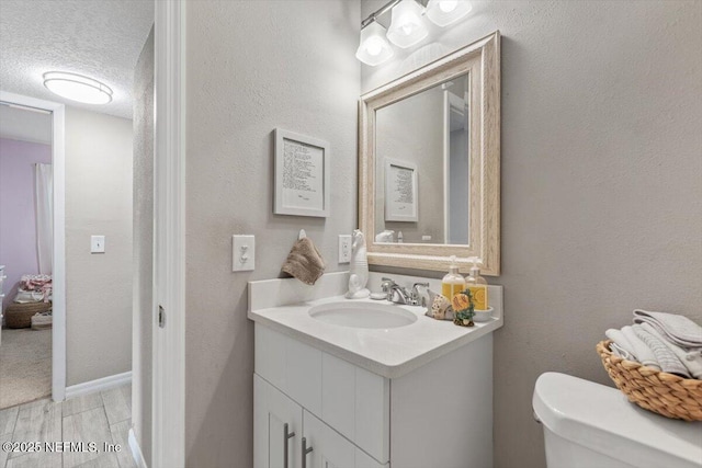 325 Sargo Rd, Atlantic Beach, FL 32233 - bathroom with vanity, a textured ceiling, and wood finished floors
