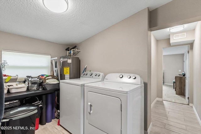 325 Sargo Rd, Atlantic Beach, FL 32233 - washroom with electric water heater, washing machine and clothes dryer, a textured ceiling, and light wood-style flooring