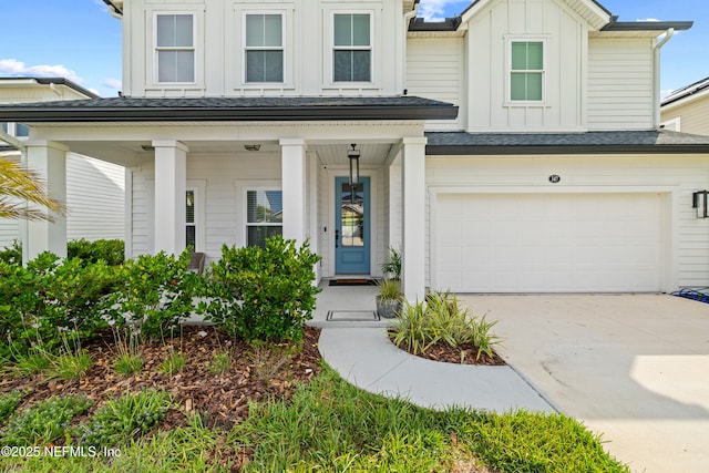 347 Ness Cir, Saint Augustine, FL 32095 - view of front of property with board and batten siding, a porch, an attached garage, and driveway