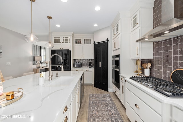 347 Ness Cir, Saint Augustine, FL 32095 - kitchen with wall chimney exhaust hood, appliances with stainless steel finishes, white cabinets, recessed lighting, and tasteful backsplash