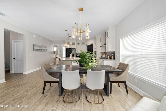347 Ness Cir, Saint Augustine, FL 32095 - dining space with a chandelier and light wood finished floors